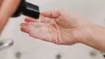 A person washing their hands with soap